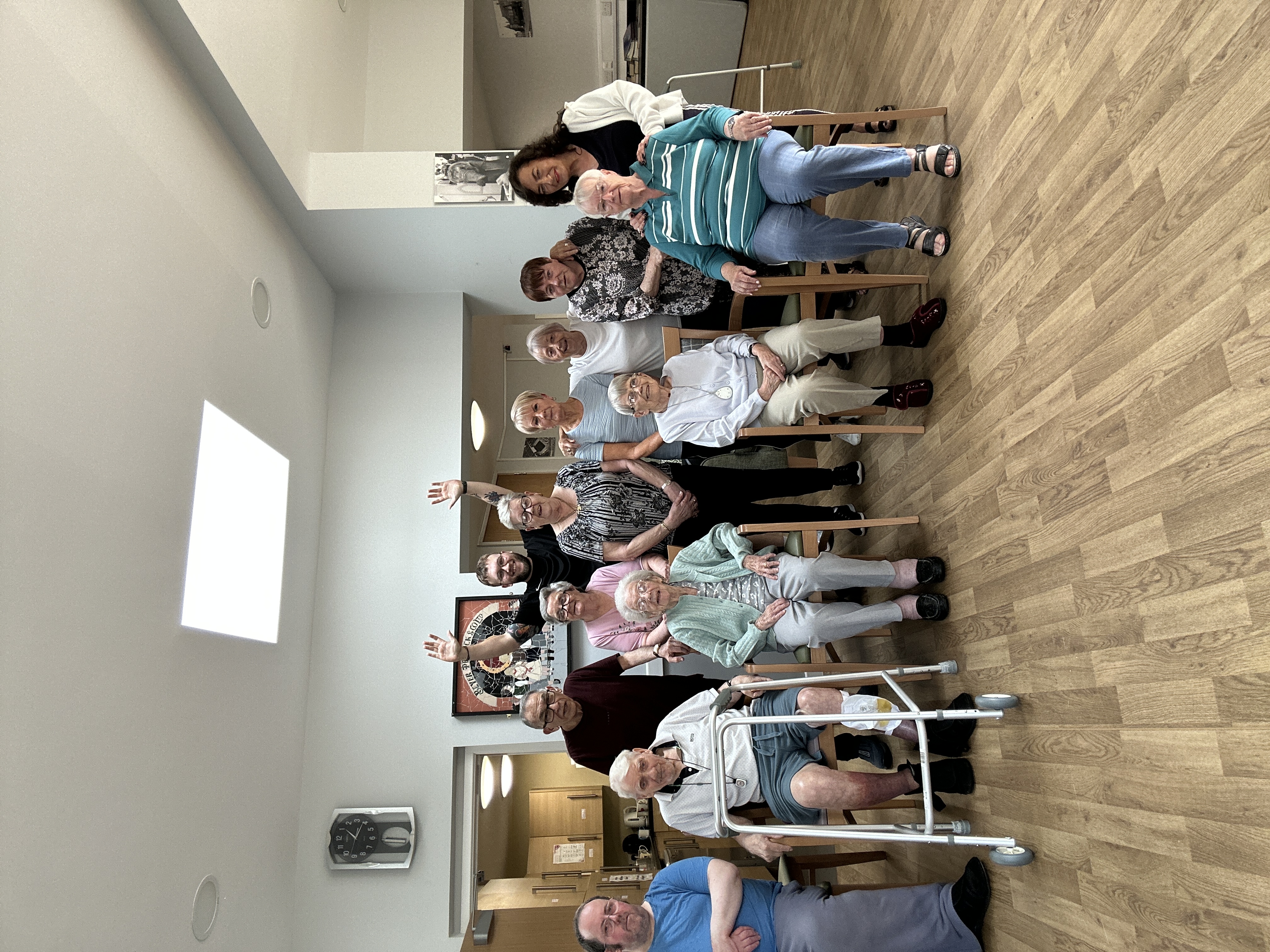 Kallum running a group chair-based exercise session with older adults
